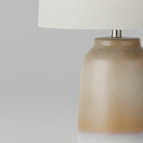 Table lamp with a beige ceramic base and white shade