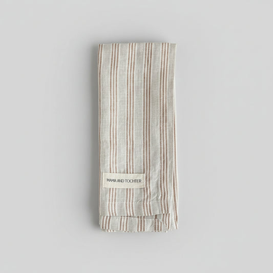 Striped tea towel with a brand label