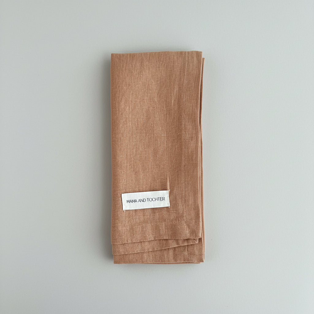 Brown tea towel with a label 