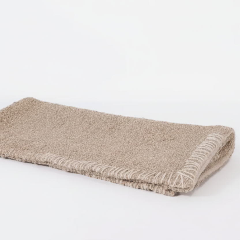 Folded beige bathmat