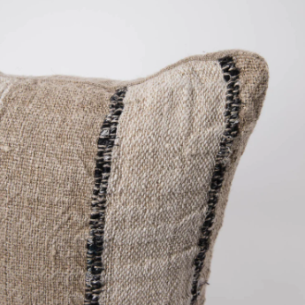 Textured pillow with black fringe detail 