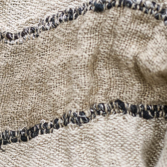 Close-up of textured fabric with a patterned edge